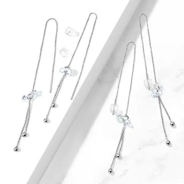 Paar threader oorbellen met hangende balletjes en steentjes